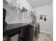 Bright laundry room featuring two machines, a countertop for folding and a wire shelf above for storage at 8812 Green Arbor Ct, Wake Forest, NC 27587