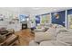 Open-concept living area featuring a fireplace with built-in shelving and ample seating with a large sectional couch at 8812 Green Arbor Ct, Wake Forest, NC 27587