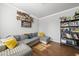 Comfortable living room with large sectional, laminate flooring, and interesting wall art at 8812 Green Arbor Ct, Wake Forest, NC 27587