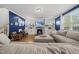 Comfortable living area with a fireplace, large sectional couch, and lots of natural light at 8812 Green Arbor Ct, Wake Forest, NC 27587