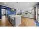 Open concept of the living room with hardwood floors and direct view of the kitchen and kitchen island at 8812 Green Arbor Ct, Wake Forest, NC 27587
