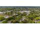 An aerial view captures a neighborhood with mature trees and businesses nearby at 905 David St, Henderson, NC 27536