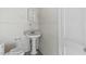 A classic bathroom featuring a pedestal sink and a toilet with white walls and trim at 905 David St, Henderson, NC 27536