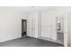 This is a bedroom with white walls, gray carpet, closet, and two doorways at 905 David St, Henderson, NC 27536
