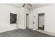 This bedroom features gray carpet, bright walls, a ceiling fan, and closet space at 905 David St, Henderson, NC 27536
