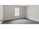 This bedroom includes gray carpet, bright walls, and a bright window at 905 David St, Henderson, NC 27536