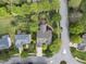 An aerial view of a home featuring a well-manicured lawn, mature trees, and a patio area with outdoor seating at 9100 Dansforeshire Way, Wake Forest, NC 27587