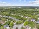 A high-angle view of a residential community with tree-covered streets and nicely landscaped properties at 9100 Dansforeshire Way, Wake Forest, NC 27587