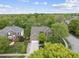 An aerial view of a brick home surrounded by mature trees and a well-maintained lawn at 9100 Dansforeshire Way, Wake Forest, NC 27587
