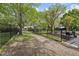 Well-maintained backyard with black metal fence, lush lawn, patio and play area at 9100 Dansforeshire Way, Wake Forest, NC 27587