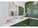 Bright bathroom with double sinks, green cabinets, and modern fixtures at 9100 Dansforeshire Way, Wake Forest, NC 27587