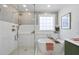 Bathroom featuring a standalone tub, glass enclosed shower, and modern gold-colored fixtures at 9100 Dansforeshire Way, Wake Forest, NC 27587