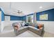 Spacious bedroom with a sofa, bed, and natural light, perfect for relaxation at 9100 Dansforeshire Way, Wake Forest, NC 27587