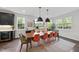 Bright dining room boasting an abundance of natural light and a modern chandelier at 9100 Dansforeshire Way, Wake Forest, NC 27587