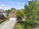 Charming two-story brick home with a well-manicured lawn and a two-car garage at 9100 Dansforeshire Way, Wake Forest, NC 27587