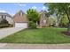 Charming two-story brick home with a well-manicured lawn and a two-car garage at 9100 Dansforeshire Way, Wake Forest, NC 27587