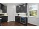 Beverage center featuring white countertops and dark cabinets at 9100 Dansforeshire Way, Wake Forest, NC 27587