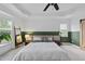 Bright main bedroom showcasing a king size bed with natural light, hardwood furniture and a tray ceiling at 9100 Dansforeshire Way, Wake Forest, NC 27587
