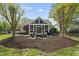 Inviting outdoor living space with screened-in porch and stone fire pit with comfortable seating at 9100 Dansforeshire Way, Wake Forest, NC 27587