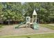 Community playground with slide, climbing structure, and shade trees at 9100 Dansforeshire Way, Wake Forest, NC 27587