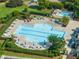 Aerial view of the community pool, featuring umbrellas, chairs and lush landscaping at 9100 Dansforeshire Way, Wake Forest, NC 27587