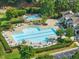 Community pool area with lounge chairs, umbrellas, and well-maintained landscaping at 9100 Dansforeshire Way, Wake Forest, NC 27587