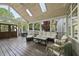 Well-lit screened porch with comfortable seating, a ceiling fan, and skylights for natural light at 9100 Dansforeshire Way, Wake Forest, NC 27587