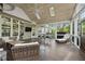 Spacious screened porch with wood ceiling, skylights, and comfortable seating areas for relaxing and entertaining at 9100 Dansforeshire Way, Wake Forest, NC 27587