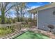 Relaxing back porch area with wooden railings and a view of the green backyard at 1008 Holloway St, Durham, NC 27701