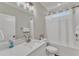 Well-lit bathroom with a white vanity, a large mirror, and a shower-tub combo at 1008 Holloway St, Durham, NC 27701