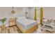 Cozy bedroom with wooden furniture, soft lighting, and bright yellow curtains at 1008 Holloway St, Durham, NC 27701