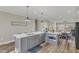 Open concept kitchen with large island, stainless steel appliances, and modern pendant lighting at 1008 Holloway St, Durham, NC 27701