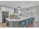 Well-appointed kitchen boasts a large island with bar seating, complemented by modern appliances and elegant lighting at 1008 Holloway St, Durham, NC 27701