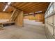 Unfinished basement with wood staircase and structural framework awaiting customization and offering potential for added living space at 1011 Parker St, Raleigh, NC 27607