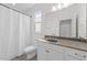 Well-lit bathroom with a granite countertop, large mirror and a shower and tub combination at 1011 Parker St, Raleigh, NC 27607
