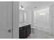 Modern bathroom features dark vanity, shower-tub combo, large mirror, and neutral color scheme at 1011 Parker St, Raleigh, NC 27607