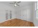Bedroom with hardwood floors, a ceiling fan and several doors and windows for natural light at 1011 Parker St, Raleigh, NC 27607