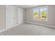 Bedroom with a window view and two closet doors at 1011 Parker St, Raleigh, NC 27607