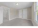 Neutral bedroom featuring carpet and window with trim at 1011 Parker St, Raleigh, NC 27607