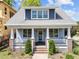 Charming home exterior with a classic front porch and well-maintained landscaping at 1011 Parker St, Raleigh, NC 27607