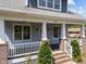 Classic front porch with sturdy columns, white railings, and a cozy ambiance at 1011 Parker St, Raleigh, NC 27607