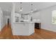 Bright, open kitchen features white cabinets, stainless steel appliances, and a convenient breakfast bar at 1011 Parker St, Raleigh, NC 27607