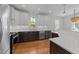Stylish kitchen features dark cabinets with stainless steel appliances and hardwood flooring at 1011 Parker St, Raleigh, NC 27607