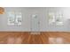 Bright living room featuring pristine hardwood floors and natural light from large windows at 1011 Parker St, Raleigh, NC 27607