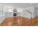 Open living room features a fireplace, built-in shelving, hardwood floors and a staircase at 1011 Parker St, Raleigh, NC 27607