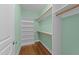 Walk-in closet featuring custom shelving and wooden rods for optimal organization and storage at 1011 Parker St, Raleigh, NC 27607