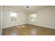 Bedroom with windows overlooking greenery and gleaming hardwood floors at 1015 Washington St, Burlington, NC 27217