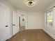 Bright bedroom featuring hardwood floors, a modern ceiling fan, and natural light from a large window at 1015 Washington St, Burlington, NC 27217