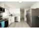 Modern kitchen with white cabinets, stainless steel appliances, and a sleek design for efficient cooking at 1015 Washington St, Burlington, NC 27217