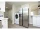 Modern kitchen features stainless steel refrigerator and a washer-dryer combo at 1015 Washington St, Burlington, NC 27217